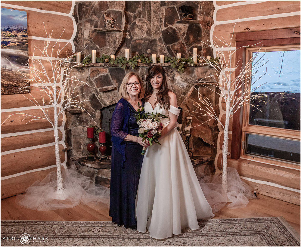 Bride with her mom in front of stone fireplace at a private home in Keystone Colorado