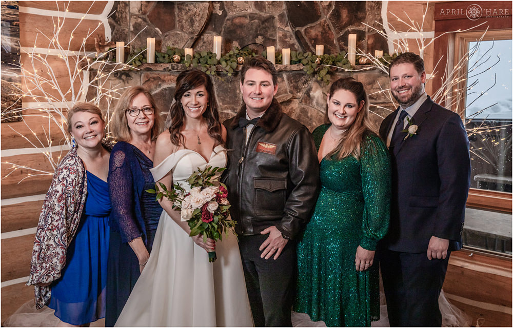 Family wedding photo in front of stone fireplace in Keystone Colorado