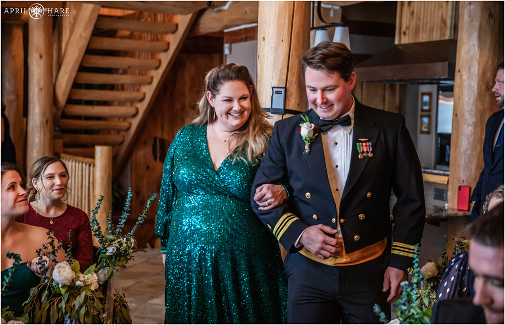 Groom walks down aisle with sister at his indoor winter wedding at private home in Keystone Colorado