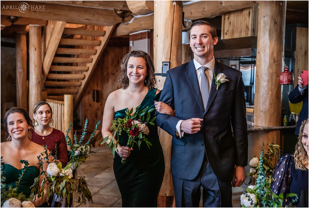 Walking down aisle at indoor cabin wedding in Keystone Colorado