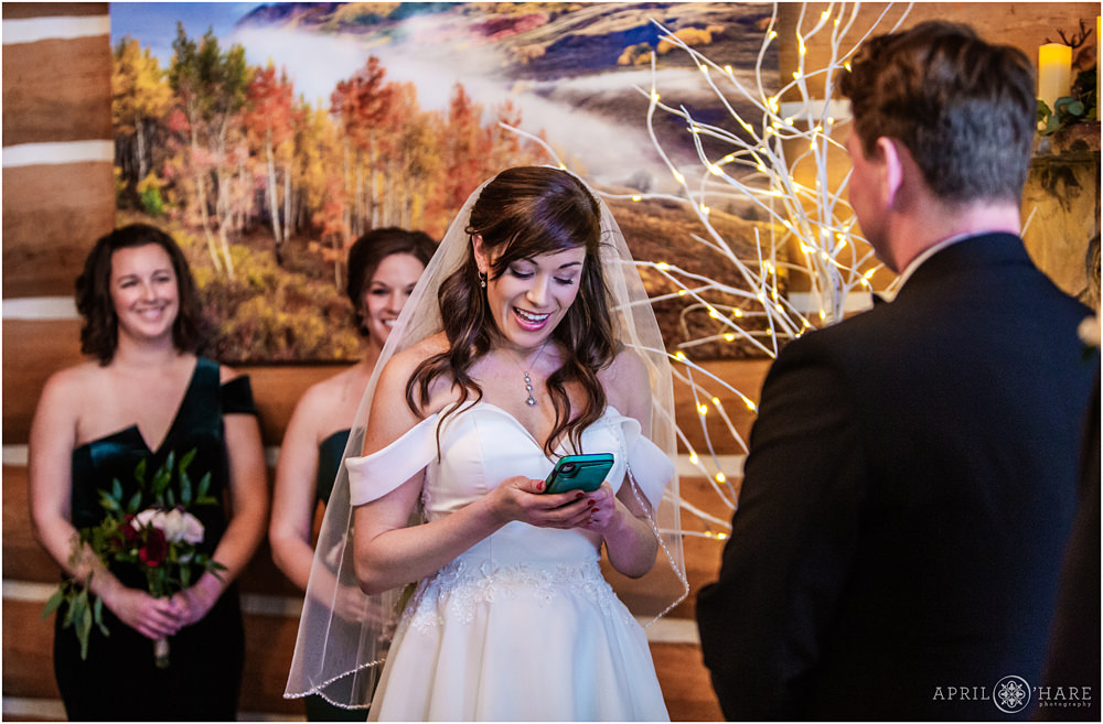 Bride reads her vows at indoor mountain cabin wedding in Keystone Colorado