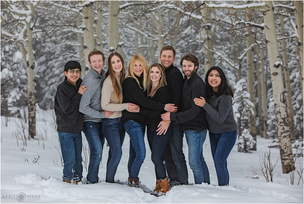 Family picture in an aspen tree forest with snow in Colorado