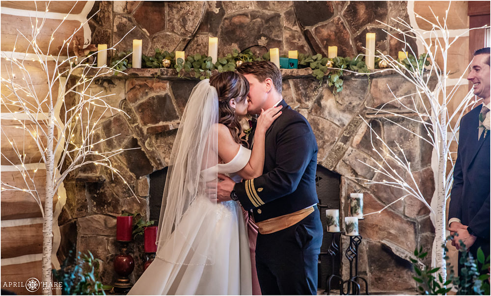 Wedding kiss at indoor wedding ceremony at private cabin home in Keystone Colorado