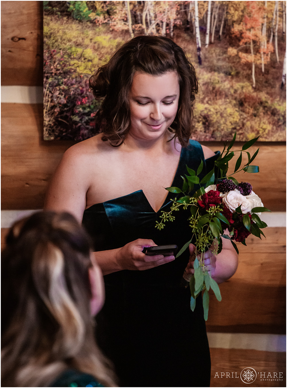 Bridesmaid reads poem at indoor private cabin wedding ceremony in Keystone Colorado