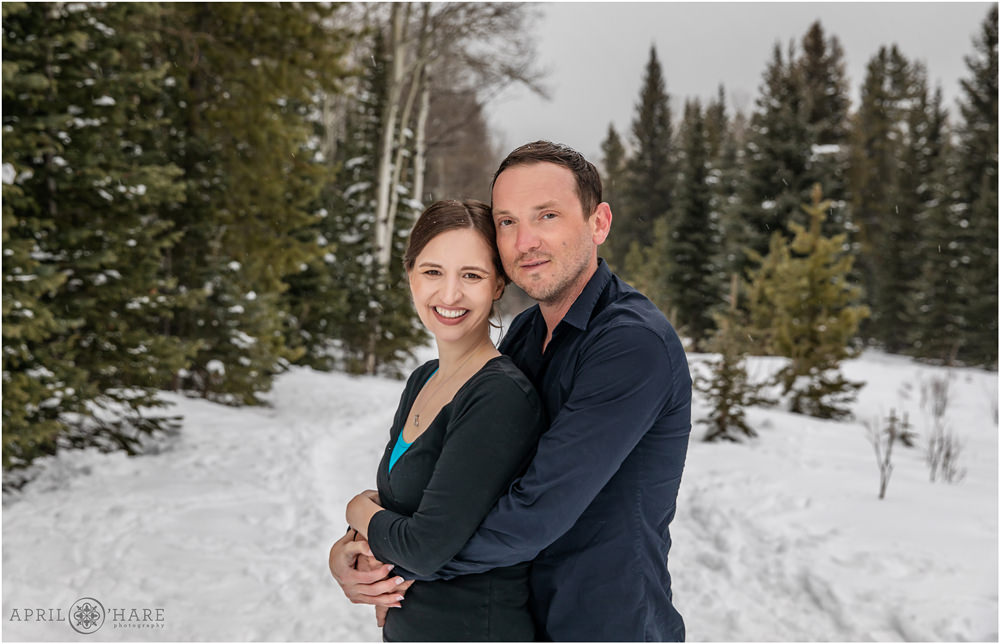 Classic couples portrait outdoors during a spring snowstorm in Evergreen Colorado