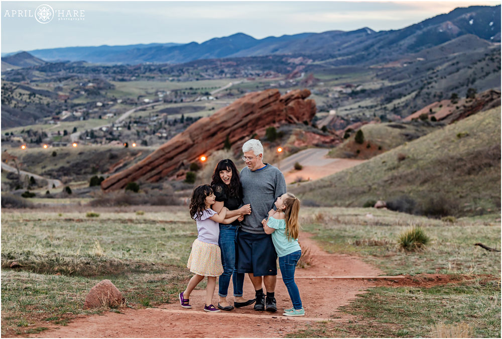 Springtime Family Photos at Red Rocks Amphitheater in Colorado for a family of 4 with two daughters on a trail to the north