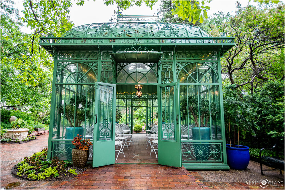 Denver Botanic Gardens Green Solarium set up for wedding ceremony on a rainy werdding day