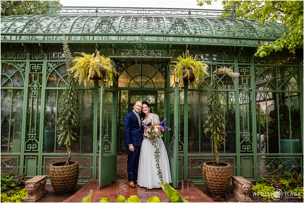 A super rainy and wet wedding day with rain coming down hard at the Woodland Mosaic Garden Solarium at Denver Botanic Gardens