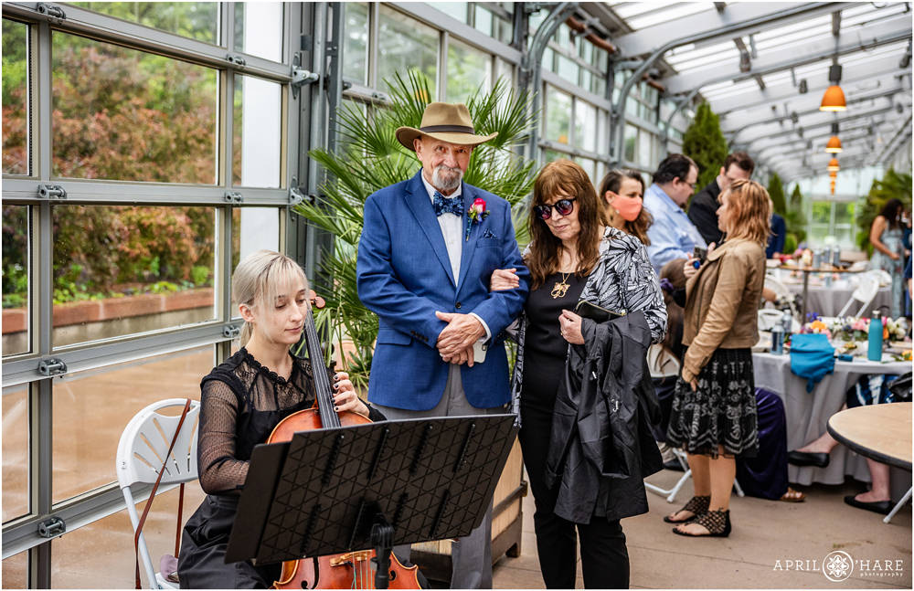 Wedding guests enjoy the cello music from Cellist Katharine Smith inside the Orangery at Denver Botanic Gardens
