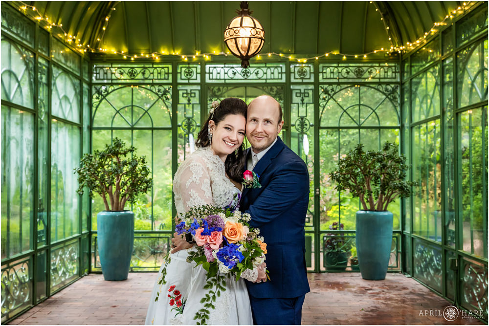 Classic wedding portrait inside the historic green solarium with Jade plants in the backdrop at Denver Botanic Gardens
