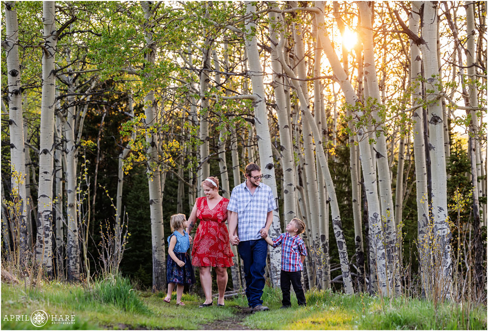 Cute photo of a blended family walking along a path in an aspen tree meadow in Colorado