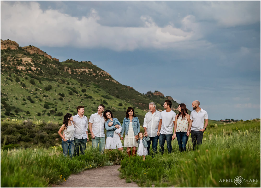 Extended family photo with everyone wearing white stand on a trail at East Mount Falcon at Sunset