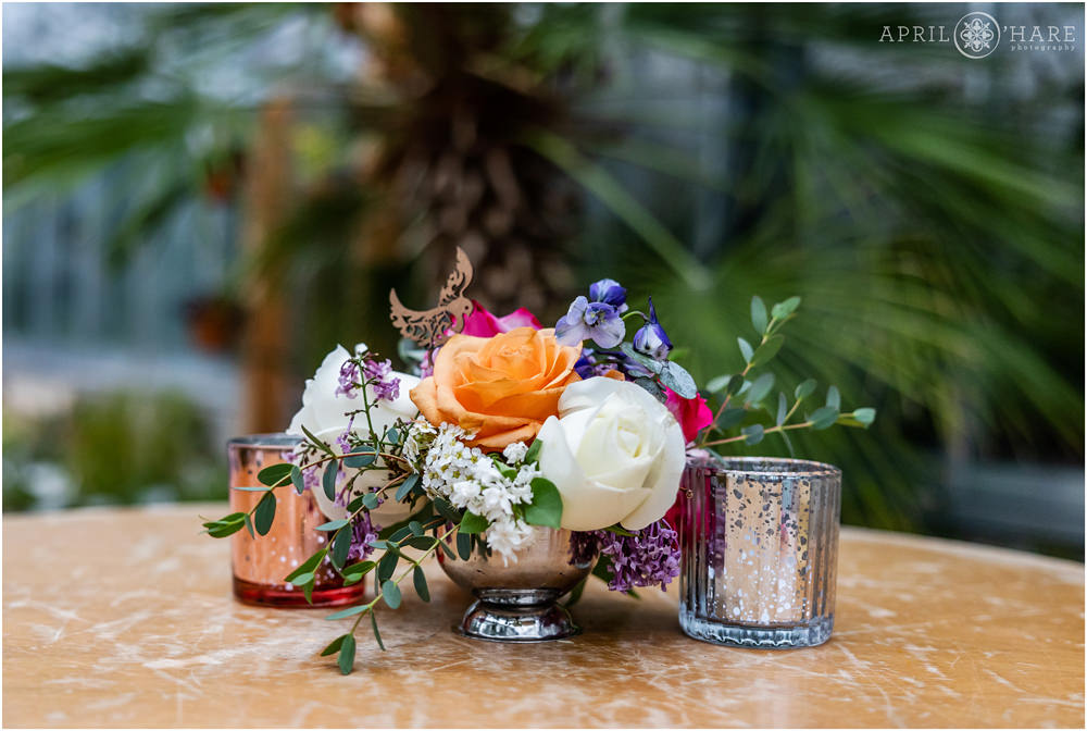 Detail photo of florals decorating a cocktail table inside the Orangery at Denver Botanic Gardens in Colorado