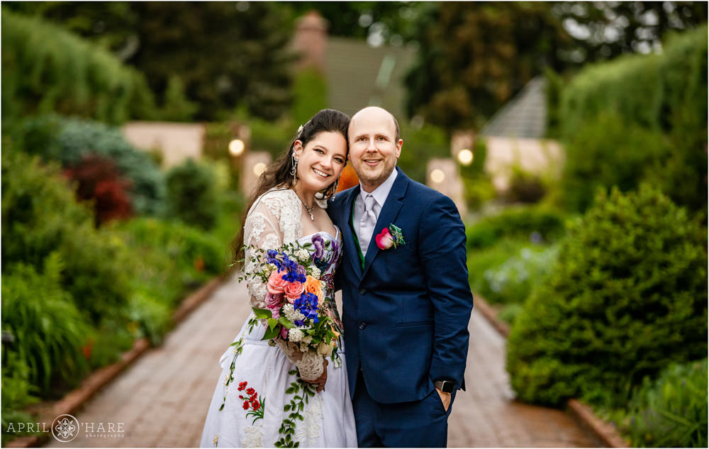 Lovely classic wedding day portrait of bride and groom on their rainy wedding day at Denver Botanic Gardens