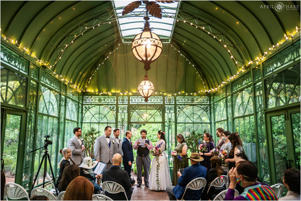 Couple gets married on a stormy rainy wedding day inside the Green solarium at Denver Botanic Gardens