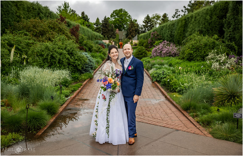 Beautiful Rainy Wedding Day Photo at Denver Botanic Gardens along the main walkway at entrance