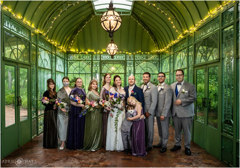 Wedding party group photo inside the Woodland Mosaic Garden historic green solarium at Denver Botanic Gardens