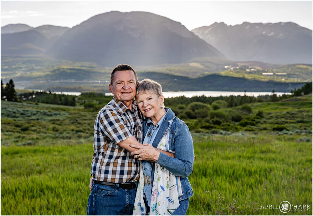 Grandparents pose for a couples photo together in front of Buffalo Mountain in Summit County Colorado