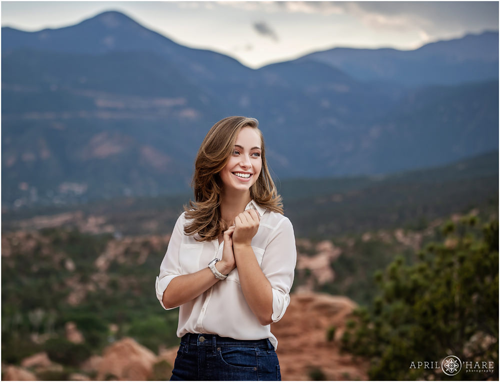 Natural senior photo for a high school senior girl wearing a white button down top at Garden of the Gods in Colorado Springs