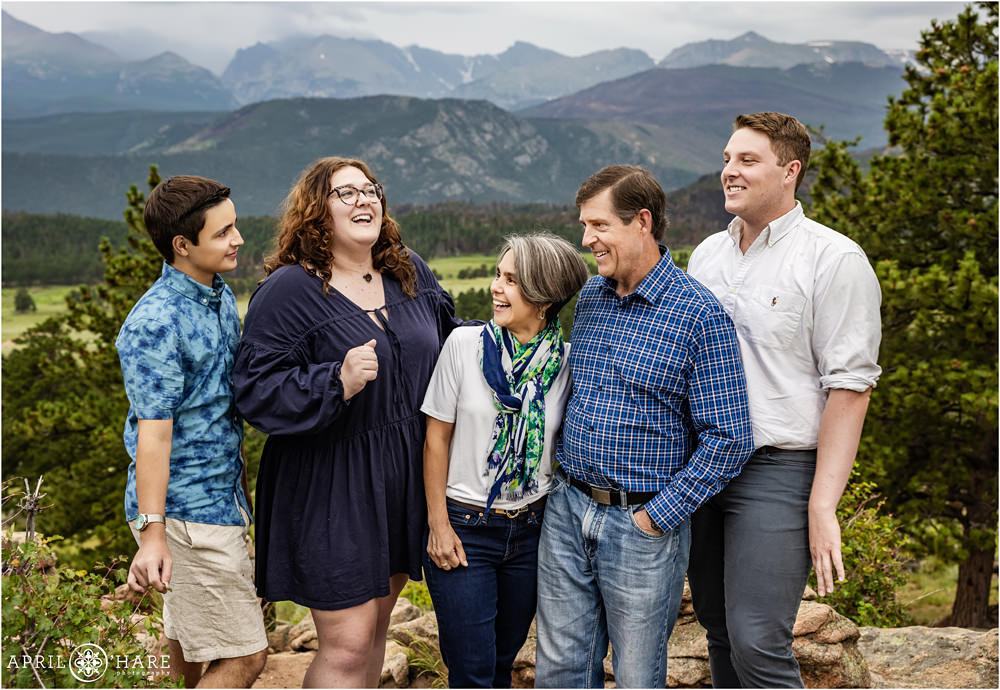 Candid photo of a family photographed in front of a mountain backdrop at Rocky Mountain National Park in Colorado