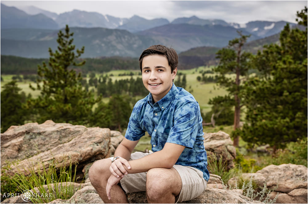 Young teen boy poses for his own portrait with a nice mountain backdrop at Rocky Mountain National Park