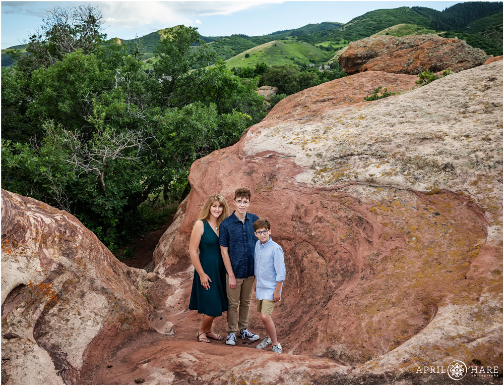 Beautiful Ken Caryl landscape with red rocks and green rolling hills for a family of 3 in Colorado