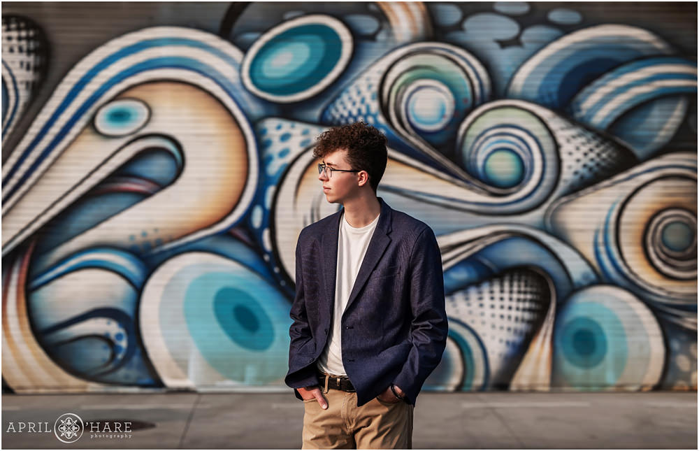 Street Art High School Senior Photos in North Denver for Boy wearing glasses and jacket