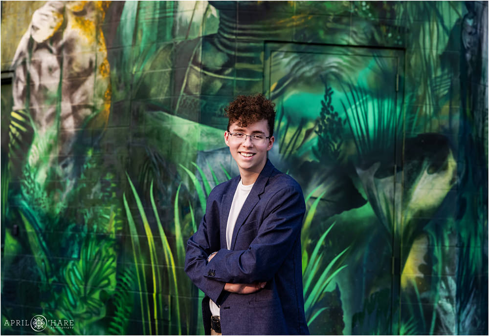Green Painted Mural Backdrop for High School Senior Boy Portrait in Denver Colorado