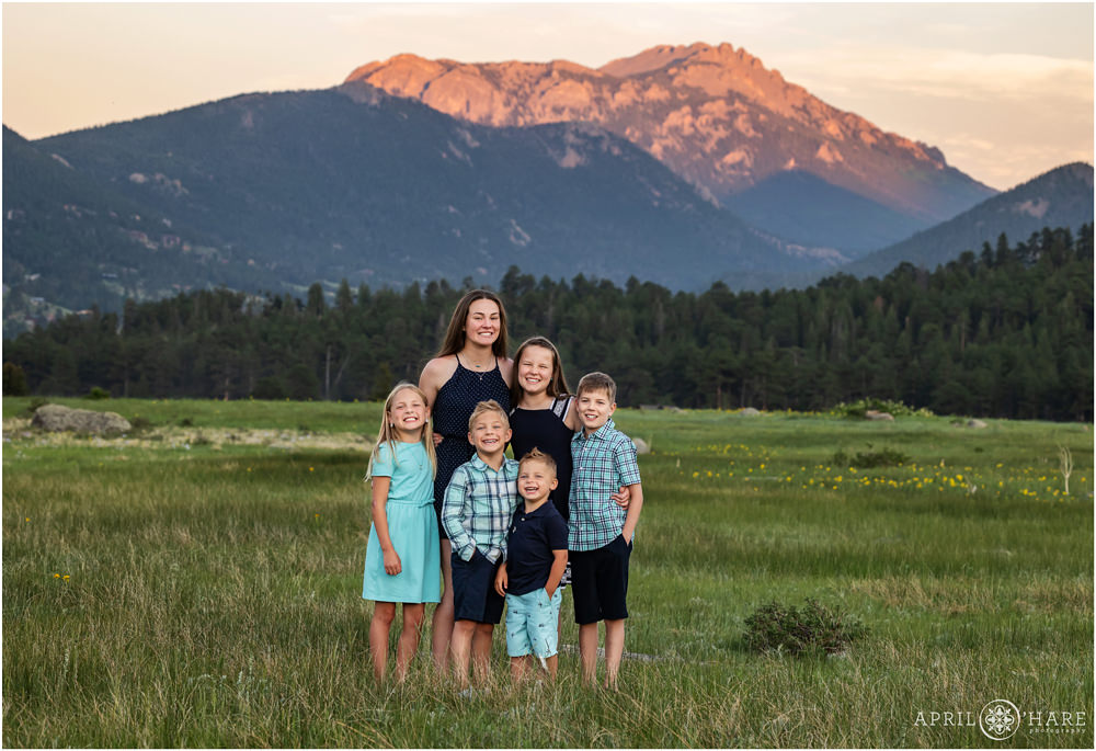 Cousins pose for portrait at sunset in a mountain meadow inside Rocky Mountain National Park