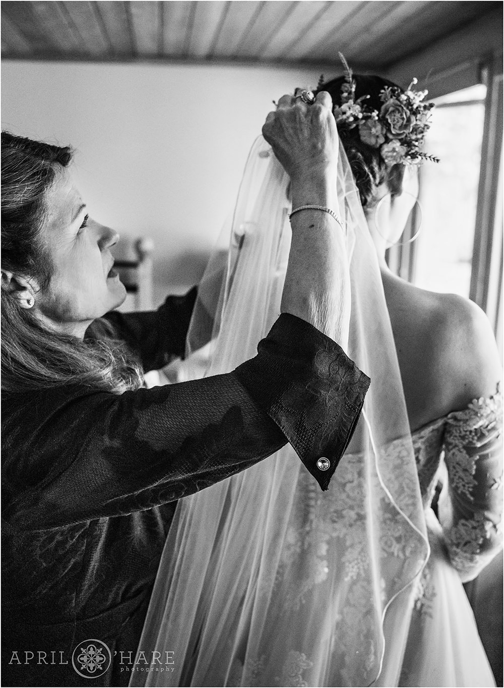 B&W photo of Mother of the bride helping her daughter with her veil