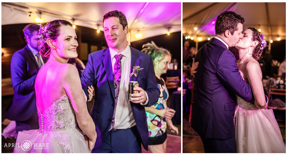 Bride and groom dance together with purple lighting at their outdoor wedding reception in Estes Park Condos