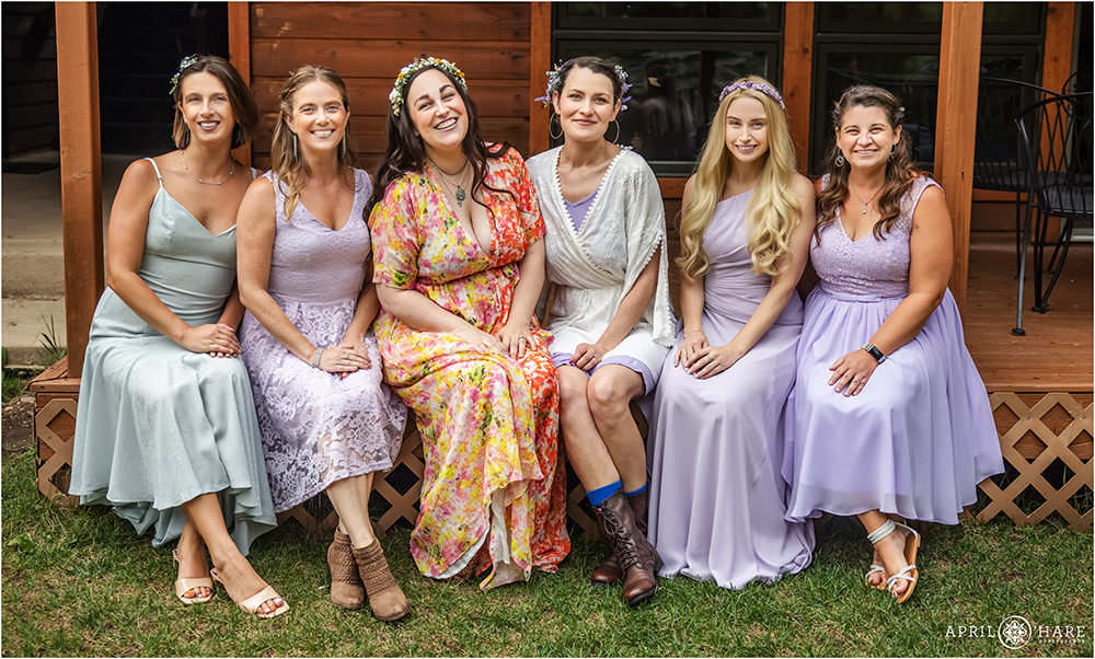 Bride and her friends pose for a photo together on the deck outside their room at Estes Park Condos