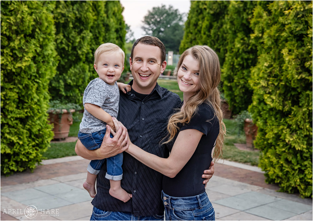 Family of 3 with a cute one year old baby boy in front of the Romantic Gardens at Denver Botanic Gardens in Colorado