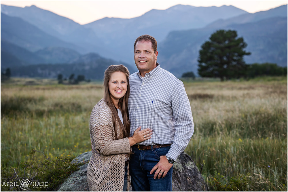A couple smile for the camera at their extended family photoshoot at Rocky Mountain National Park