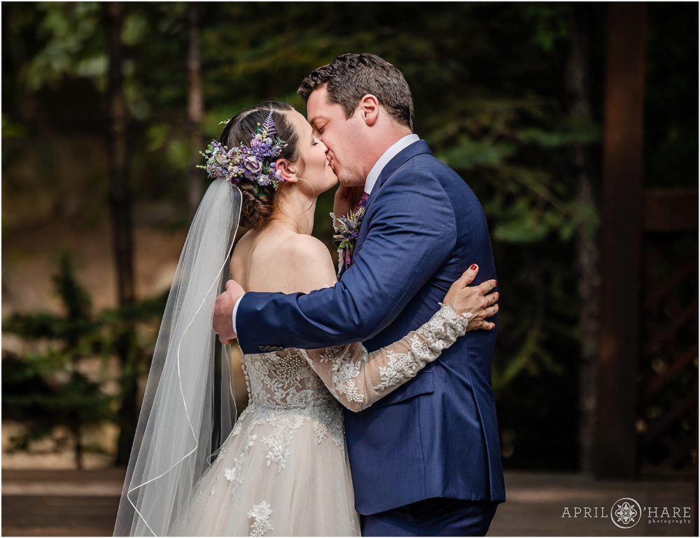 Bride and groom kiss on their wedding day at end of their wedding ceremony at Estes Park Condos