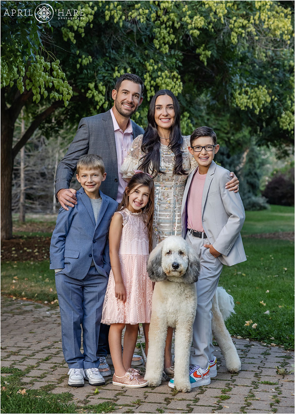 Family of 5 with their white goldendoodle dog at Gallup Gardens in Littleton Colorado