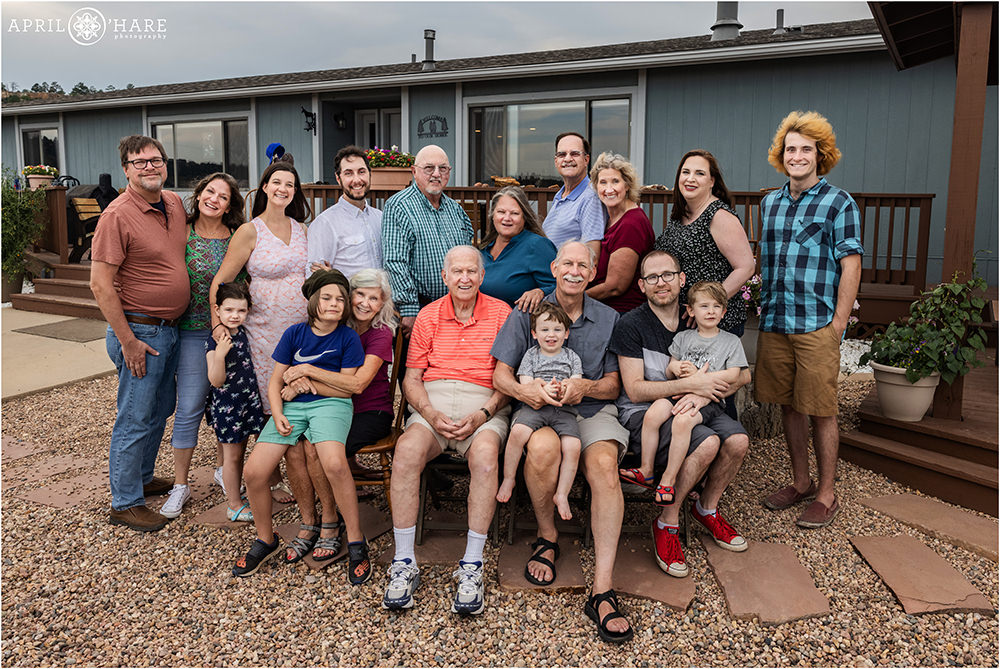 A large extended family pose for a photo together in front of a ranch house in Elizabeth Colorado