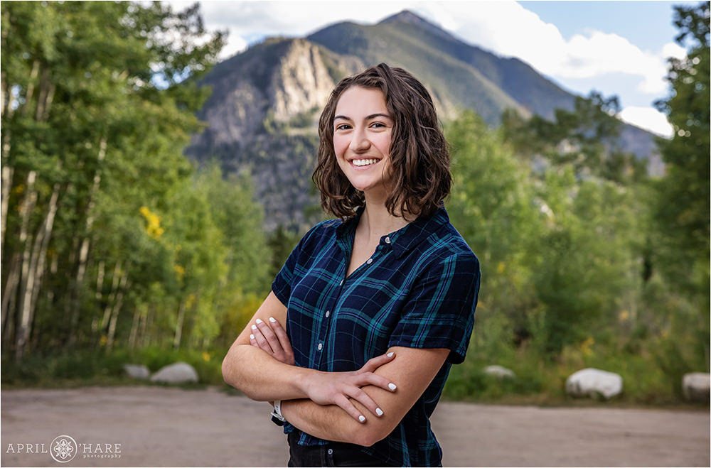 High school senior girl with Mount Royal in the backdrop at the Meadow Creek Trailhead in Frisco Colorado