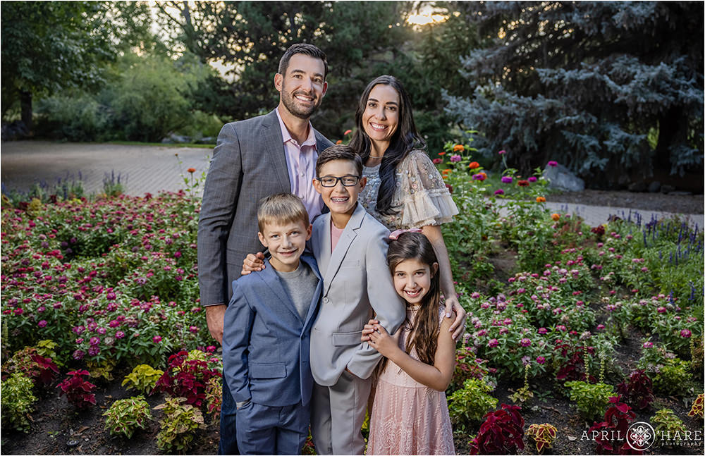 Cute Family of 5 posing for family picture in Gallup Gardens Littleton Colorado in August