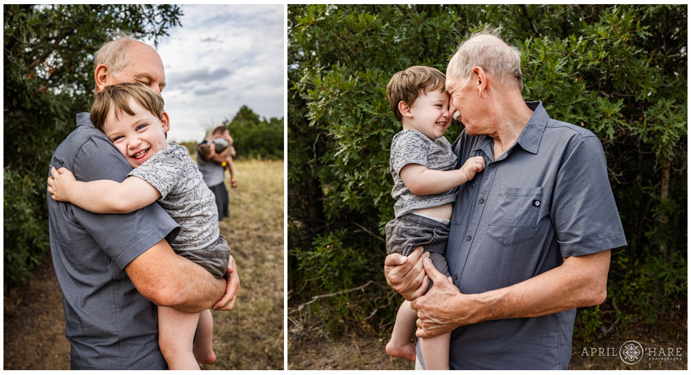 Grandfather and his grandson snuggle at a family reunion on a private ranch in Elizabeth Colorado