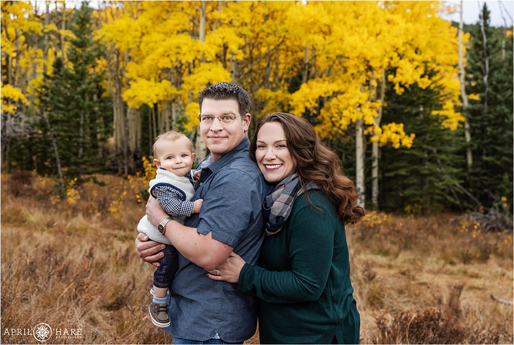 Family of 3 in the fall color with a cute 8 months old baby in Evergreen Colorado