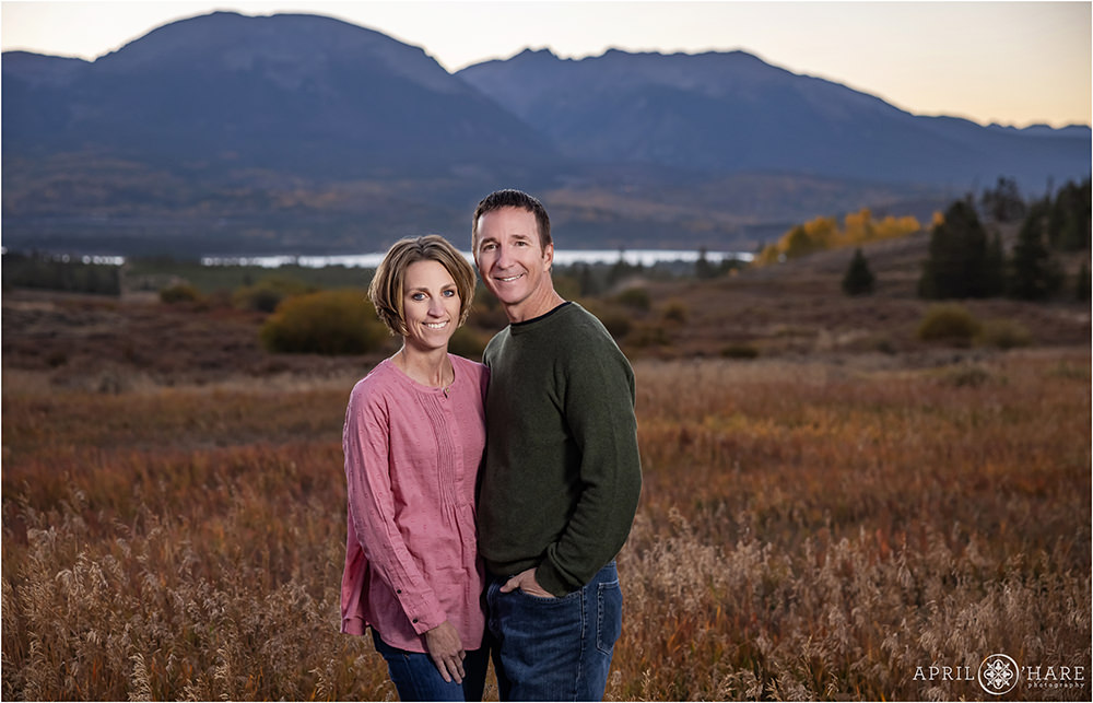 Parents pose alone with Buffalo Mountain backdrop in Summit County Coloraod during fall