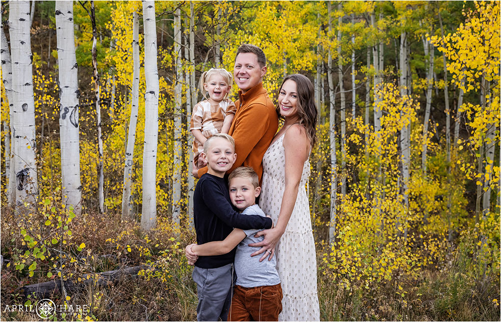 A cute family of 5 with golden aspen fall color backdrop in Summit County Colorado