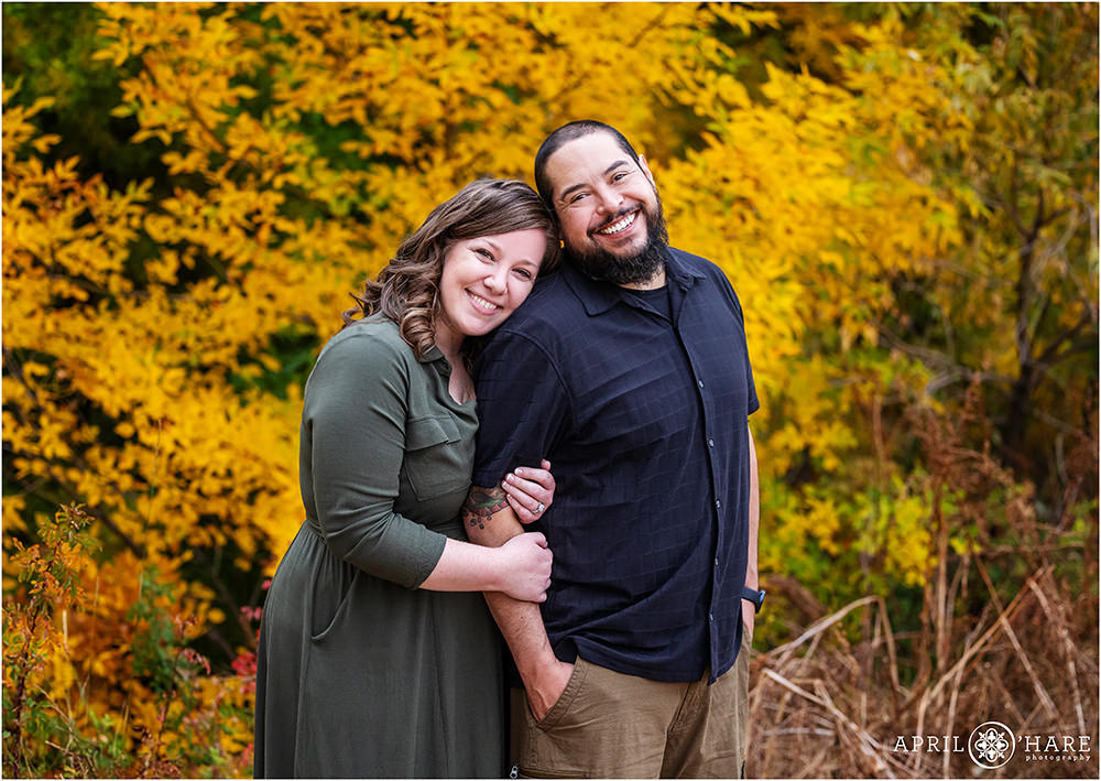 Beautiful couples portrait with pretty fall color backdrop at James A. Bible Park in Denver CO