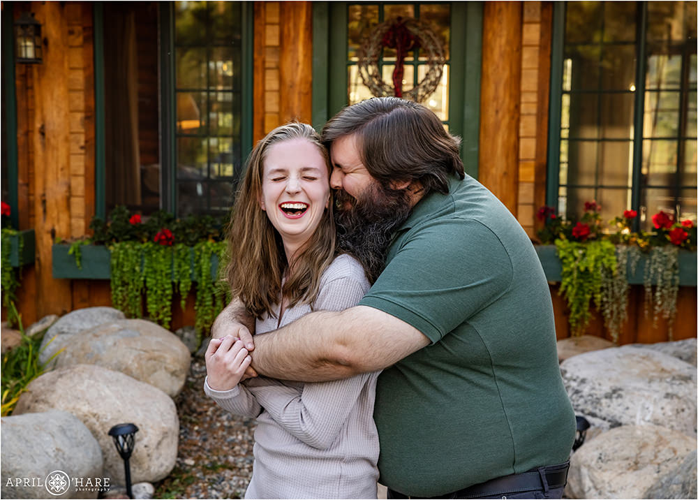 Sweet couple portrait with them snuggling at a Colorado mountain cabin home in Grand Lake