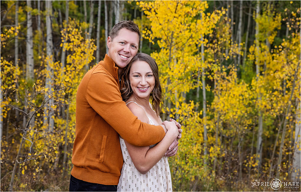 Mom and Dad get a photo by themselves without the kids with pretty aspen leaves in the backdrop