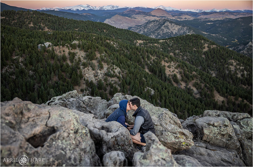 Couple gets engaged and then kisses with a beautiful sunrise mountain backdrop at Lost Gulch Lookout in Boulder