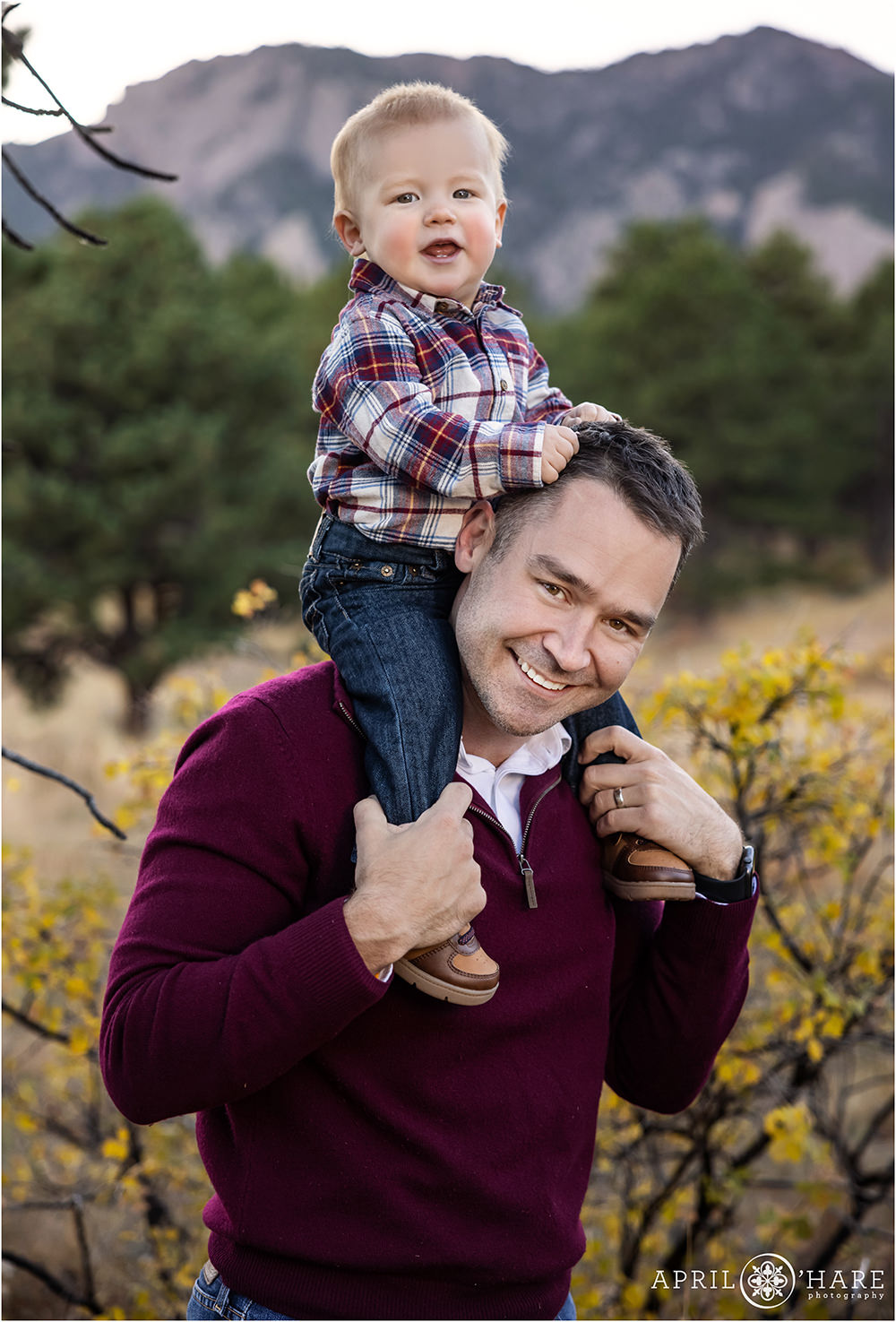 Sweet baby boy rides on his dad's shoulders with a pretty Boulder Colorado backdrop