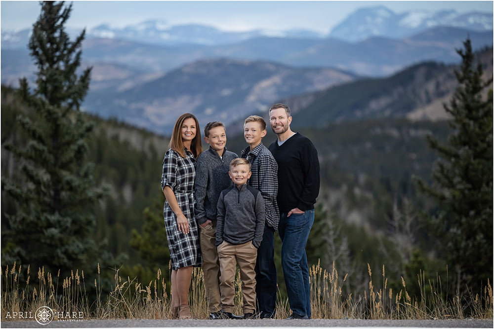 Gorgeous Mountain Backdrop for a Family portrait with 5 people wearing black and gray in Evergreen