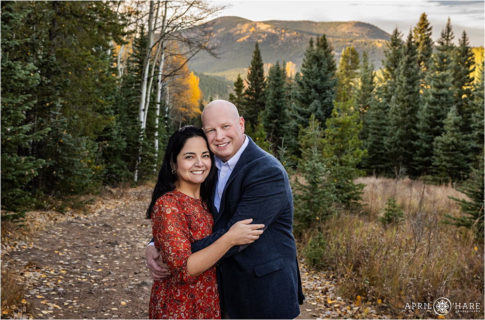 Mom and Dad alone for a couples portrait in front of a pretty fall color backdrop in Evergreen CO